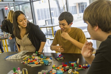 Engineering professor Candace Chan, a nanoscientist, checks in with undergraduate students Ruben Hernandez (aeronautics major) and Dylan Baker (mechanical engineering major) as they work on their LEGO models